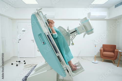 Adult man taking radiograph an X-Ray machine to scan for injury