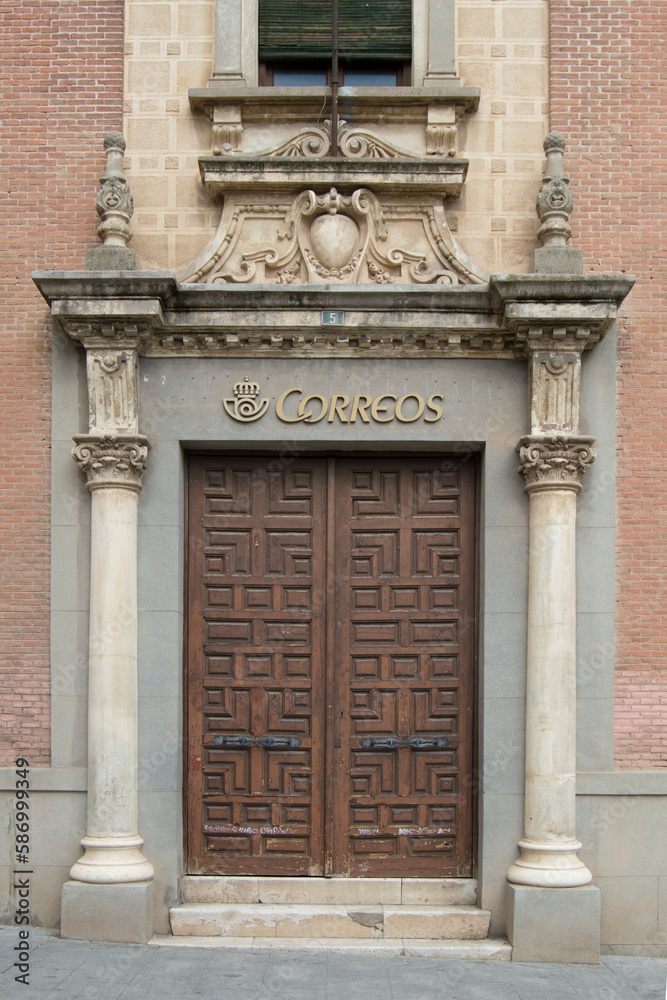 Entrance door to a post office in a Renaissance building in Guadalajara. Spain. The sign on the door says post office in Spanish