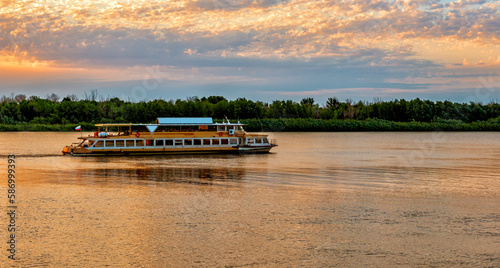 A ship is sailing on a large river photo