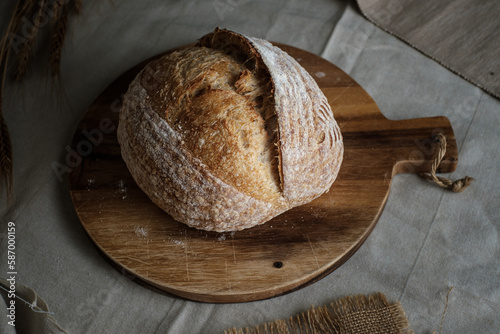 Artisan Batard Sourdough healthy Bread. Open crumb high hydration Sourdough french country bread set on dark background. © Tavan