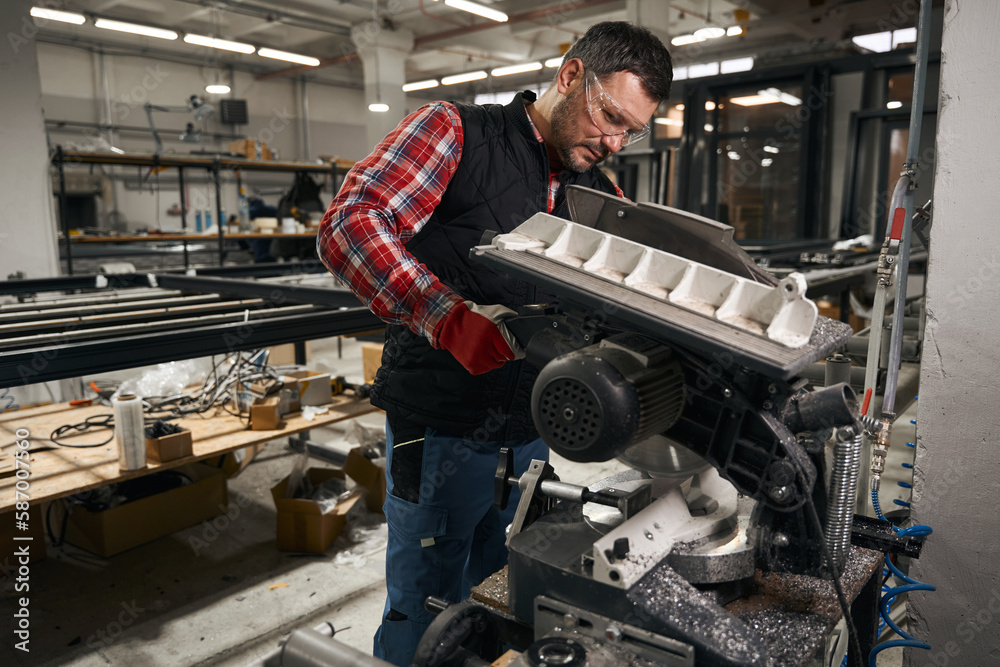 Adult male using equipment in the workshop