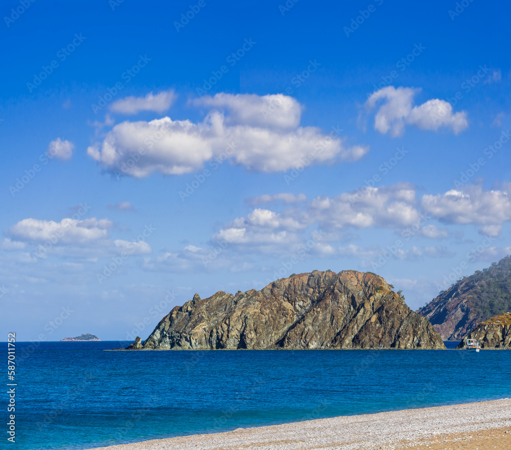 emerald sea bay with sandy beach under cloudy sky