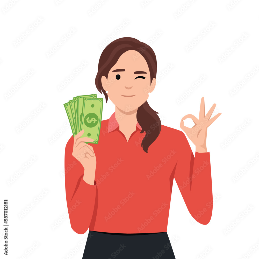 Young woman holding cash or currency or money in hand and showing OKAY or OK sign Young woman holding cash or currency or money in hand and showing OKAY or OK sign