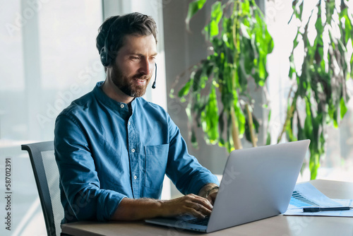 Young man in blue shirt having a business call