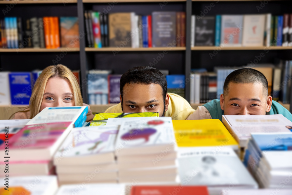 Students hiding behind the bookshelves Students hiding behind the bookshelves