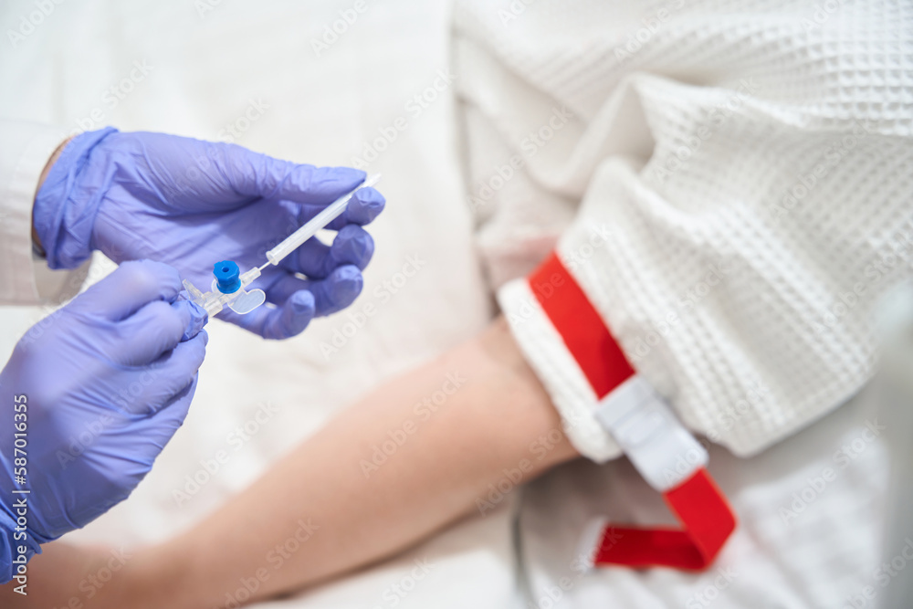 Unrecognized doctor with infusion drip in the sickroom