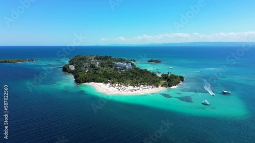 Aerial pull back motion away from tropical island Cayo Levantado. Turquoise Caribbean sea and yachts. Popular tour to Samana, Dominican Republic photo