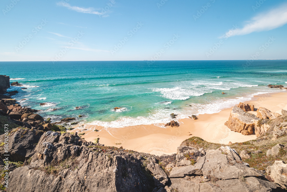 Rocks surround the sandy beach of Praia do Malhao Sul on the Atlantic coast near Vila Nova de Milfontes, Odemira, Portugal. In the footsteps of Rota Vicentina. Fisherman trail