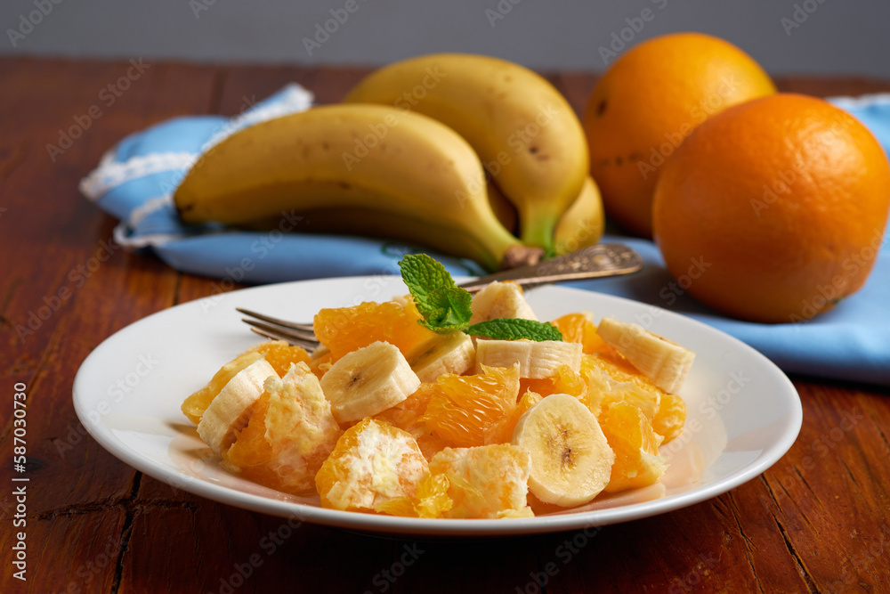 Sliced bananas and oranges