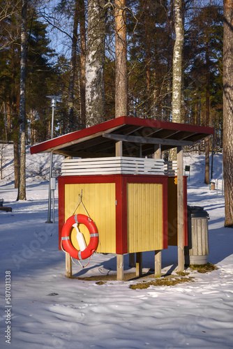 Yellow wooden beach hut in winter, Vaaksy, Finland. photo