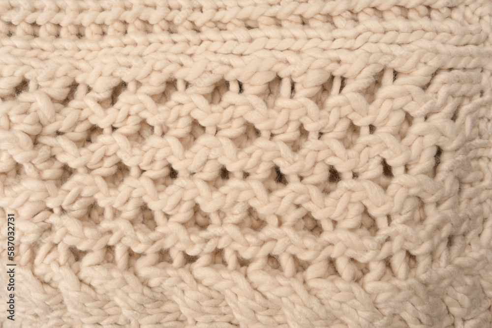 A fragment of beige knitted fabric, knitted from white sheep wool. A fragment of beige knitted fabric, knitted from white sheep wool.