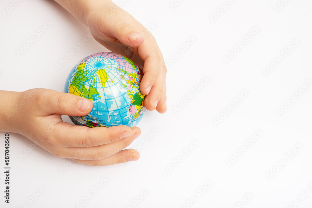 Environment for future, save the planet concept. World globe in child hands top view with copy space Environment for future, save the planet concept. World globe in child hands top view with copy space