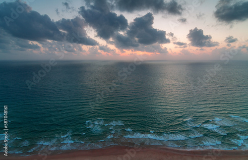 Sea coast, aerial view. Clean sea, waves and sunset