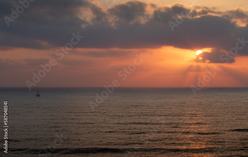 Sea panorama. Sailboat goes on the waves during sunset