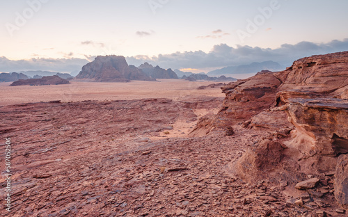 Red orange Mars like landscape in Jordan Wadi Rum desert  mountains background  overcast morning. This location was used as set for many science fiction movies