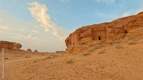 Old Nabatean architecture carved on orange sandstone wall at Jabal Al Ahmar, Hegra in Saudi Arabia, 18 ancient tombs are located here, 111 in whole Mada in Salih archaeological site photo
