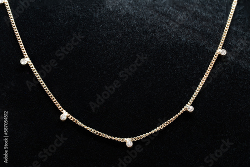 Gold chain jewelry with diamonds embedded in the chain macro photography