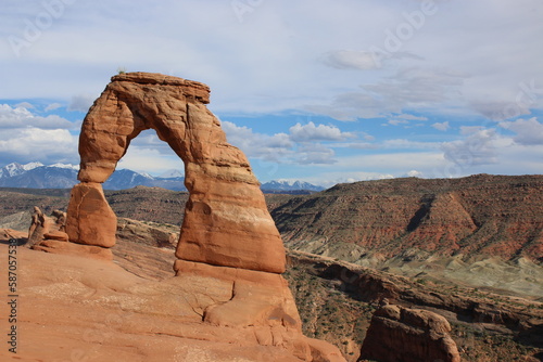 Delicate Arch in Utah desert with Mountains behind