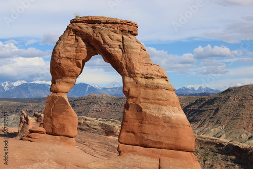Delicate Arch in Utah desert with Mountains behind