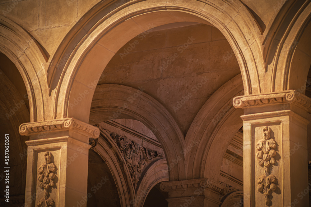 Play of light with the semicircular arches of the cloister of the Convento de la Merced from the 16th century in Lorca, Murcia, Spain