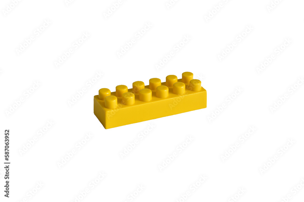Yellow plastic part of a children's blocks constructor lies on a white background. Yellow plastic part of a children's blocks constructor lies on a white background.