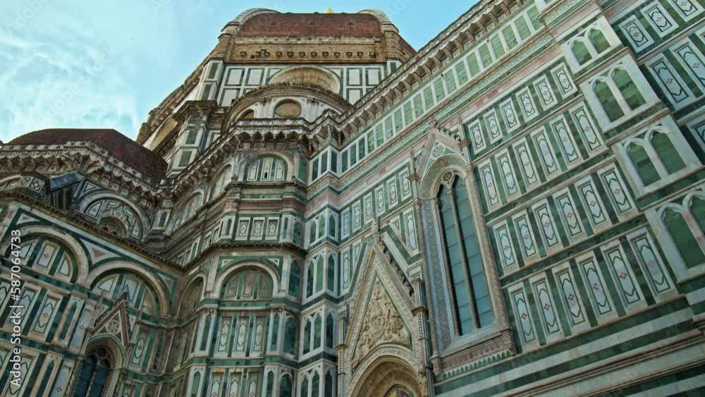 Close-up of the stunning Cathedral of Santa Maria del Fiore. Amazing Landmark cathedral with red-tiled dome, colored marble facade and elegant Giotto tower in Florence, Italy. Close-up of the stunning Cathedral of Santa Maria del Fiore. Amazing Landmark cathedral with red-tiled dome, colored marble facade and elegant Giotto tower in Florence, Italy.
