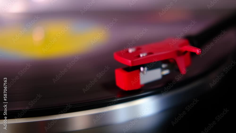 close-up of black vinyl record, disk is spinning, colored lights, analogue retro music concept, audio experience, relaxation, musical enjoyment, vintage technology, nostalgia for the past close-up of black vinyl record, disk is spinning, colored lights, analogue retro music concept, audio experience, relaxation, musical enjoyment, vintage technology, nostalgia for the past