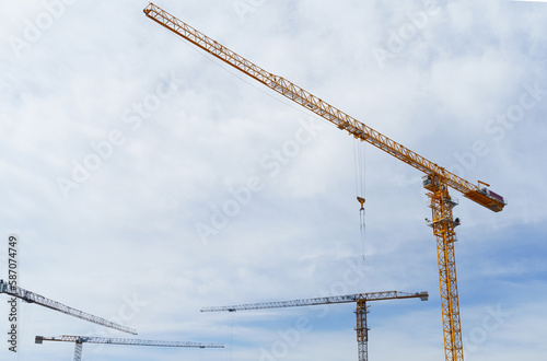 Construction cranes against the blue sky. Bottom view. © Dzmitry