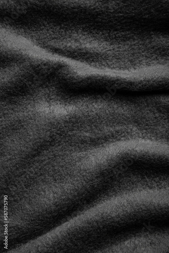 Texture of warm woolen fabric with folds. Gray wavy felt back.