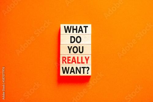 What do you really want symbol. Concept words What do you really want on wooden block. Beautiful orange table orange background. Business what do you really want concept. Copy space.