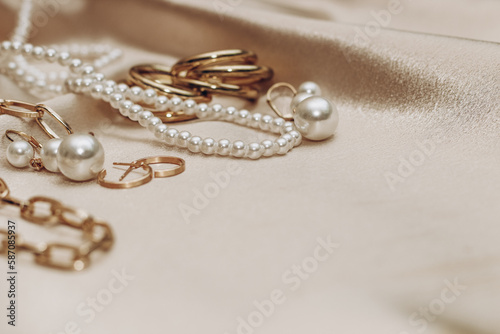 Women's jewelry, gold chain, trendy jewelry on a silk background.