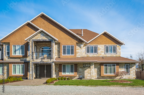 Real Estate Exterior Front House on a sunny day Big custom made luxury house with nicely landscaped front yard