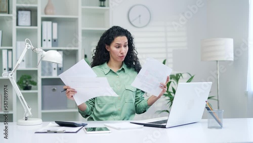 puzzle financier at workplace with paper work young hispanic arabic woman accountant problems prepares financial repor taxes and finance entrepreneur small business owner is stressed with paperwork photo