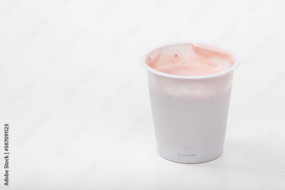Delicious Strawberry Yogurt in White Cup on White Background Delicious Strawberry Yogurt in White Cup on White Background