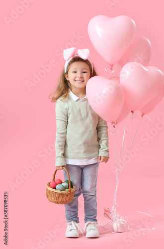 Little girl in bunny ears w...