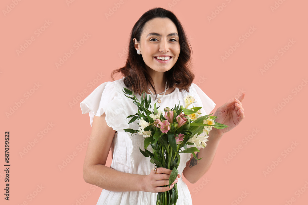 Young woman in dress with alstroemeria flowers on pink background Young woman in dress with alstroemeria flowers on pink background