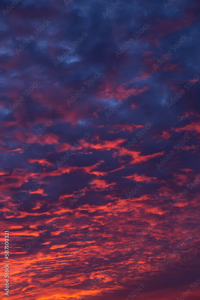 Epic dramatic sunset, sunrise on storm sky with dark and red clouds, in sunlight
