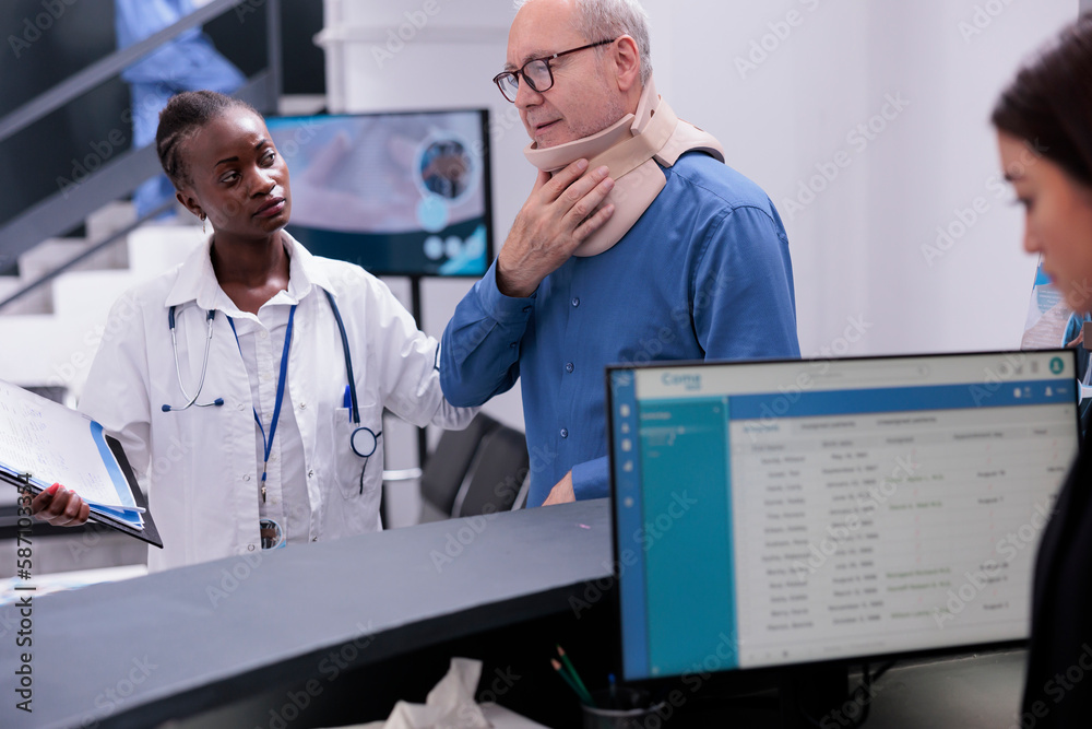 Senior patient with neck collar explaining symptoms to physician doctor asking for painkillers in hospital waiting area. Injured man with cervical foam waiting to attend checkup visit consultation Senior patient with neck collar explaining symptoms to physician doctor asking for painkillers in hospital waiting area. Injured man with cervical foam waiting to attend checkup visit consultation