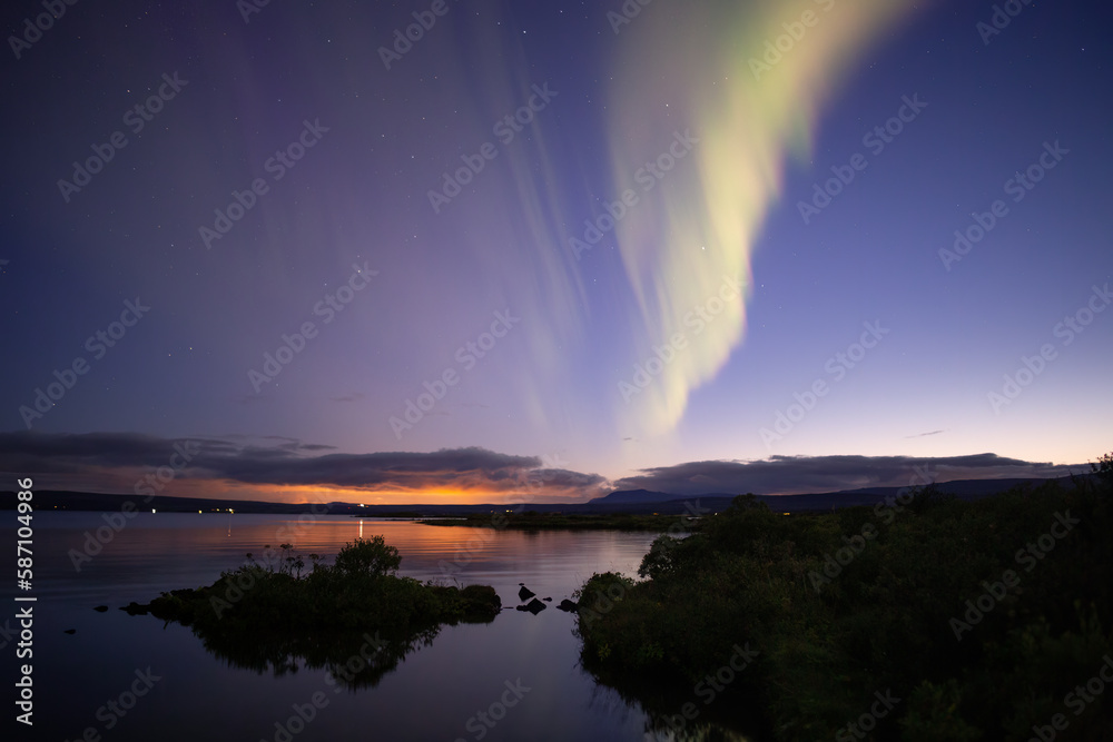 Aurora borealis over Thingvellir lake at dusk, Iceland
