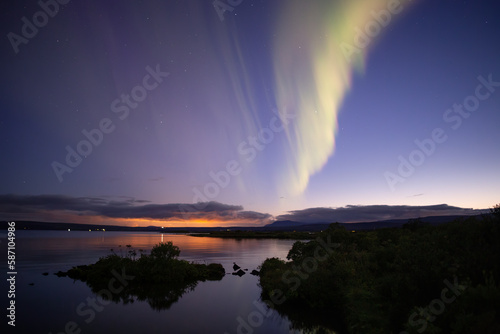 Aurora borealis over Thingvellir lake at dusk, Iceland