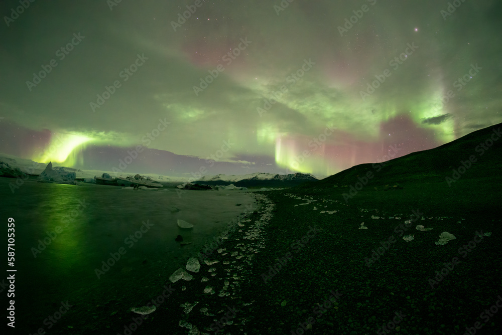 Aurora borealis over Jokulsarlon lagoon ice walkway, Iceland