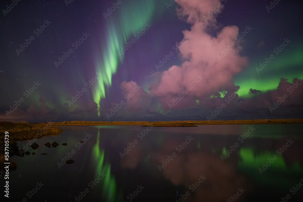 Aurora borealis mirror reflection in lake, Grotta Iceland