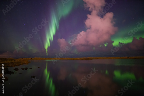 Aurora borealis mirror reflection in lake, Grotta Iceland © Arctic Mystic