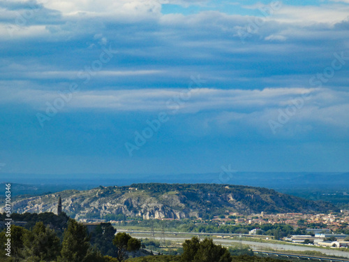 Magnificent landscape from the heights of the Alpilles in Provence in France on the iconic Saint-Jacques hill and part of the town of Cavaillon on the right © Sebastien
