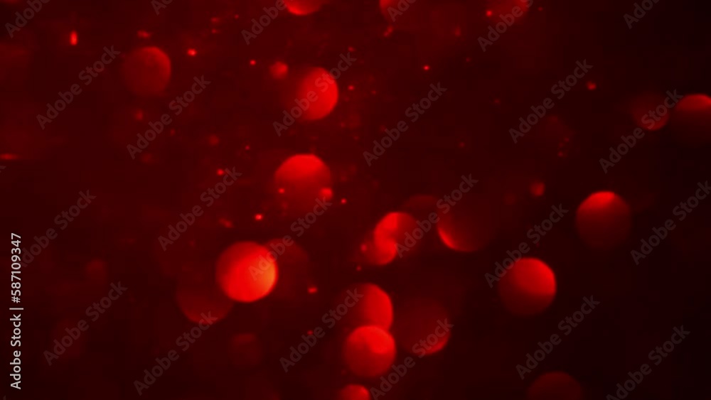 Shimmering red bokeh and dust particles motion. Abstract background of moving red blurred circles. Bokeh Lights in red.