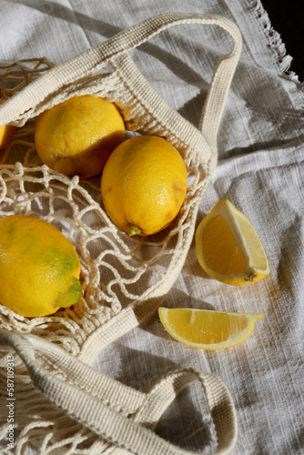 Fototapeta Naklejka Na Ścianę i Meble -  fresh lemons in cotton eco string bag