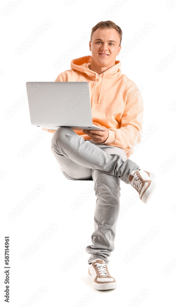 Young guy using laptop in chair on white background Young guy using laptop in chair on white background