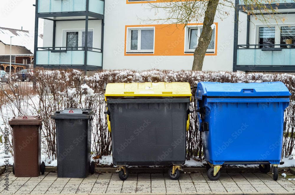 View of garbage containers in city on winter day View of garbage containers in city on winter day