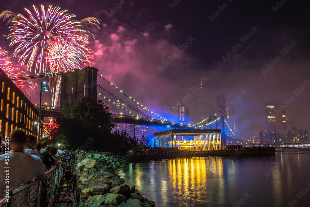 USA, New York, July: Fireworks during the celebration independence day in the USA. People are watching fireworks nearby Brooklyn bridge