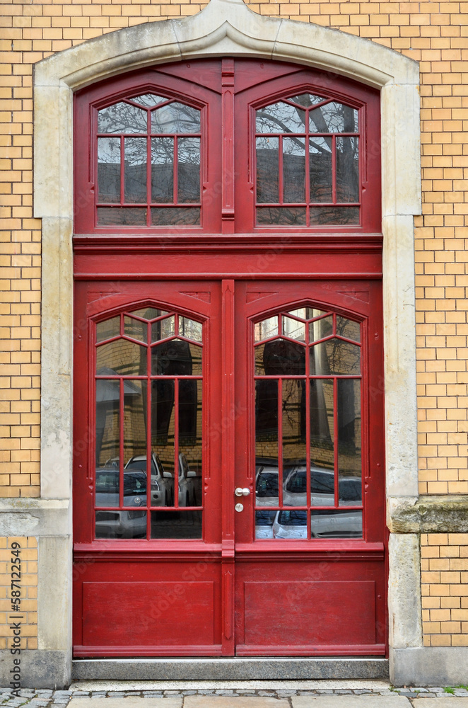 View of brick building with red wooden door View of brick building with red wooden door